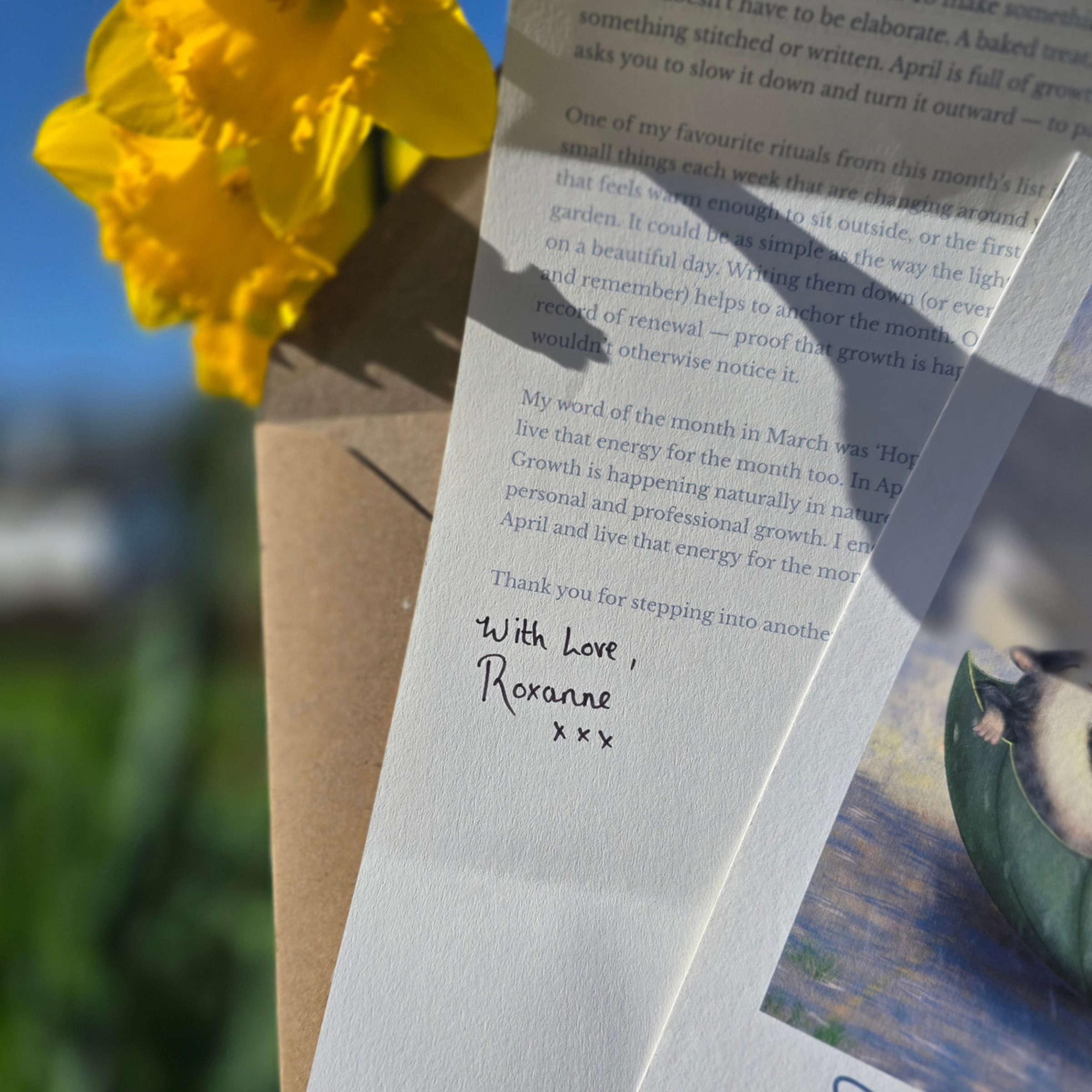 Letter with a yellow flower daffodil and a squirrel illustration on a blurred natural background