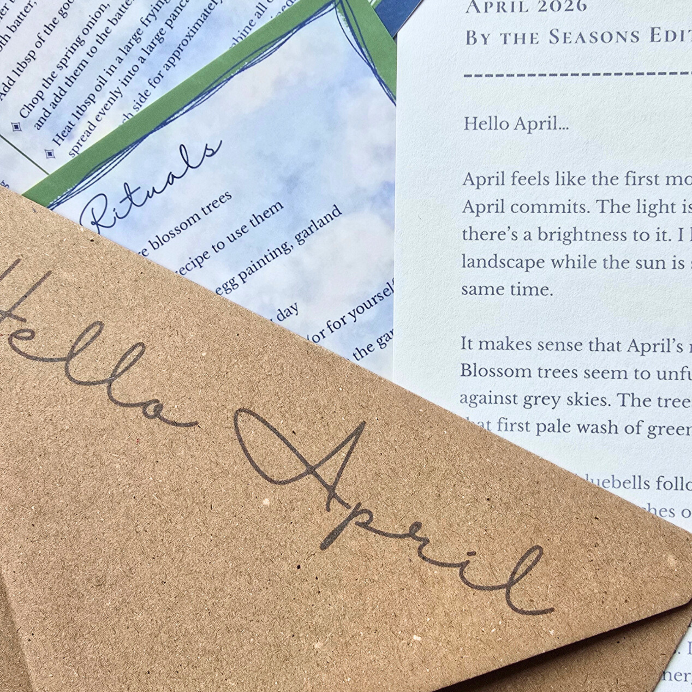 Brown paper with 'Hello April' text on a background of printed pages.