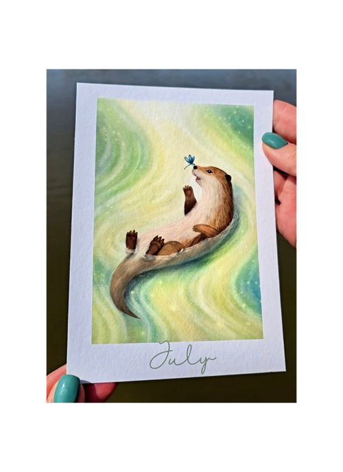 Illustration of an otter holding a dragonfly on a card held by hands with green nail polish.