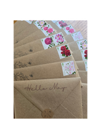 brown kraft envelopes with rose stamps and illustrations