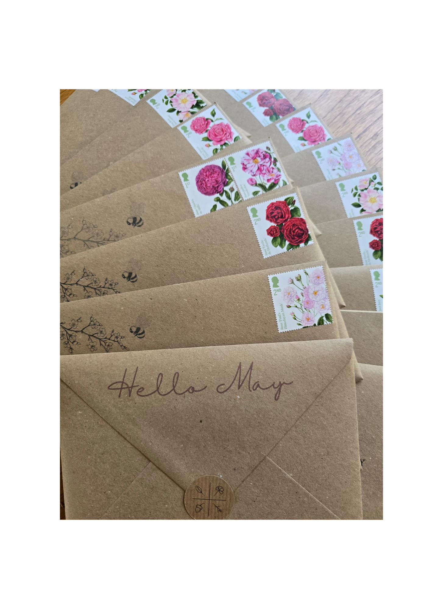 brown kraft envelopes with rose stamps and illustrations
