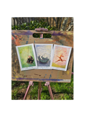 three art prints on an easel
