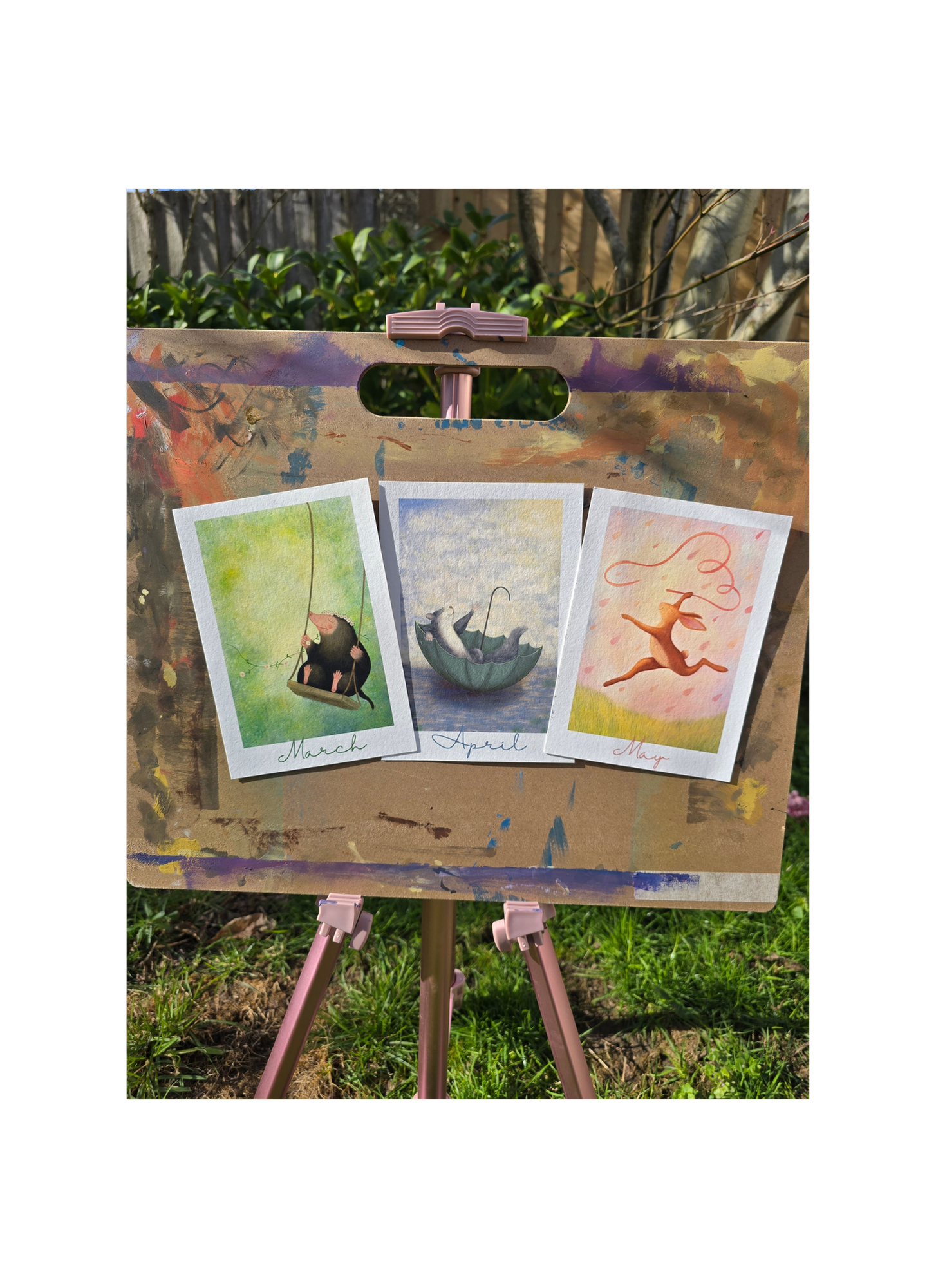 three art prints on an easel