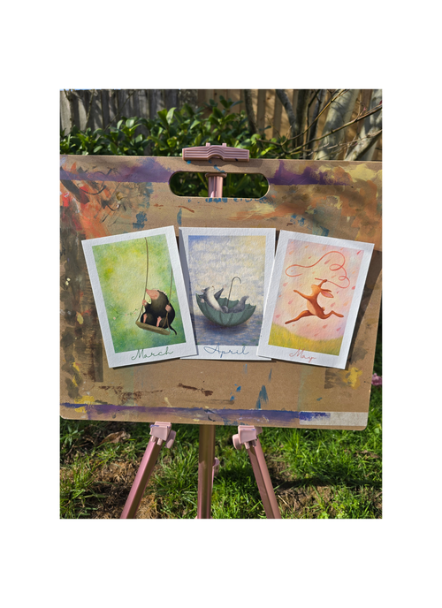 three art prints on an easel